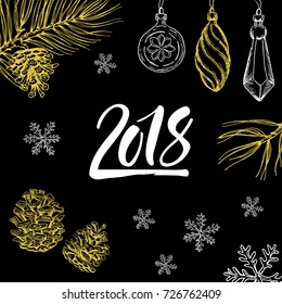 New Year 2018 hand written symbol with christmas decorations and pine branches on background.