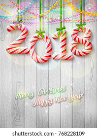 New Year 2018 in shape of candy stick as christmas decoration. Holiday congratulation against wood background