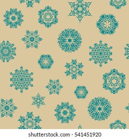 New Year 2019 collection. Beige, green and blue snowflakes seamless pattern in abstract style. Freehand ethnic Xmas sketch. Ornamental artistic vector sketch for Merry christmas cards on a beige.