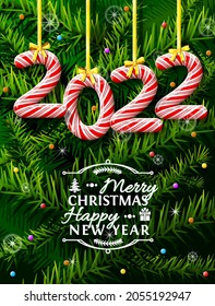 New Year 2022 in shape of candy stick against pine branches. Year number like holiday candies