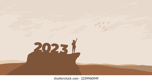 New Year 2023 concept. Man meets dawn in mountains for new year 2023. New Start motivation inspirational quote message on silhouette man