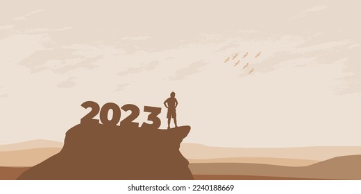 New Year 2023 concept. Man meets dawn in mountains for new year 2023. New Start motivation inspirational quote message on silhouette man