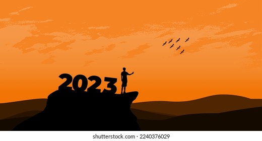 New Year 2023 concept. Man meets dawn in mountains for new year 2023. New Start motivation inspirational quote message on silhouette man