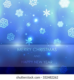 New year blue blurred background with snowflakes with text Marry Christmas And Happy New Year
