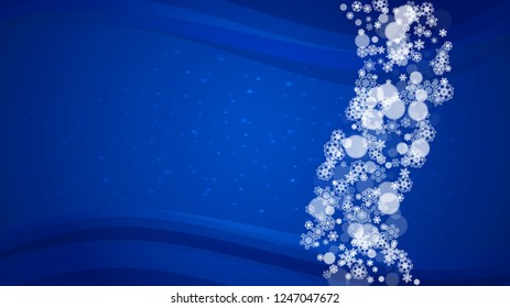 New Year border on blue background. Horizontal winter theme. Christmas and New Year border with snowflakes  falling. For season sales, special offer, banners, cards, party invites, flyers. White snow