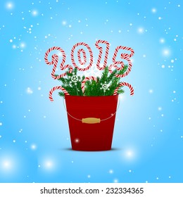 New Year bucket with candy canes, fir branches and snowflakes