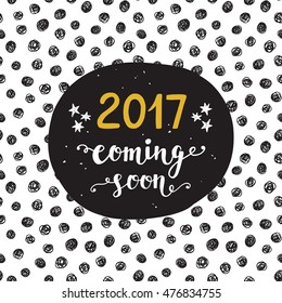 New Year card. "2017 year coming soon" modern unique hand lettering in golden and black colors. Trendy typography design for placards, posters, flyers, banners. Modern calligraphy