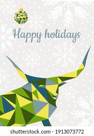 New Year card "Happy Holidays" with snowflakes on a gray background. A multicolored bull with large horns in trendy colors: blue, green and yellow. Vector polygonal graphics.