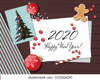 New year and Christmas background with cookie, greeting card and christmas balls. Top view.