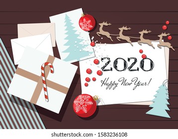 New year and Christmas background with gift, greeting card and christmas toys. Space for text. Top view.