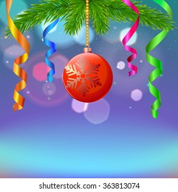 New year composition with serpentine and Christmas ball on blurred background
