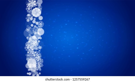 New Year frame with cold snowflakes on blue horizontal background with sparkles. Christmas and New Year frame for gift certificates, ads, banners, flyers, sales offers, event invitations. Falling snow