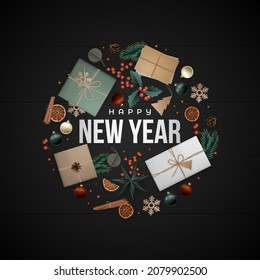 New Year greeting card. Flat lay composition. Christmas elements laid out in circle shape on black wood floor. Scandi style. 