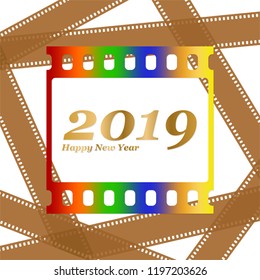 New year greetings for 2019 with colorful blank film and photographic window with golden inscription Happy new year and number 2019 on a background of brown film strips