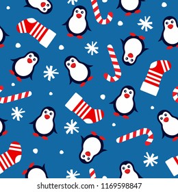 new year seamless background with penguins, christmas socks, candy cane and snowflakes on a blue background