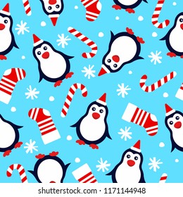 new year seamless background with penguins in the hat of Santa Claus, christmas socks, candy cane and snowflakes on a blue background