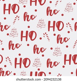 New Year seamless pattern with lettering, Christmass tree and candy on white background. Santa's text HO ho ho in red color. For textile, wrapping paper, greeting card etc. Christmass illustration
