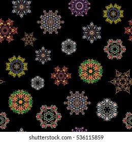 New year snowflake. Cute abstract seamless snowflakes vector design on black background. Flat snow doodle icons, snow flakes silhouette in pink, blue and yellow colors for christmas banner, cards.