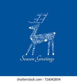 New Year Winter Season Holidays greeting card. Playful reindeer sign from ornate white snowflakes on blue background. Abstract deer icon. Christmas seasonal symbol. Vector decorative illustration