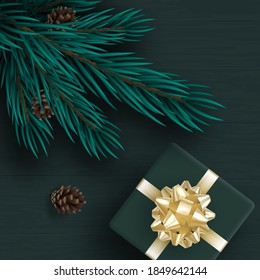 New year's background. On the boards is a pine branch with cones, and a gift box tied with a Golden ribbon and a bow. Green shade. Merry Christmas. Realistically. For the design of stores and websites