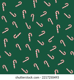 NEW YEAR'S SEAMLESS PATTERN WITH NEW YEAR'S CANDY ON A GREEN BACKGROUND.
