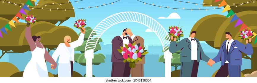 newlywed gay couple with flowers kissing near wedding arch transgender love LGBT community wedding celebration