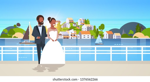 newlyweds african american couple standing together bride and groom embracing wedding day concept mountain city island landscape background horizontal