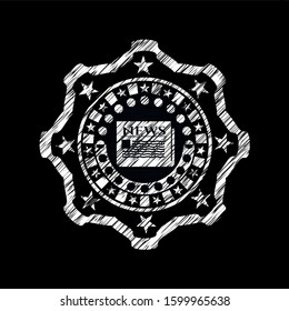 newspaper icon inside chalk emblem written on a blackboard