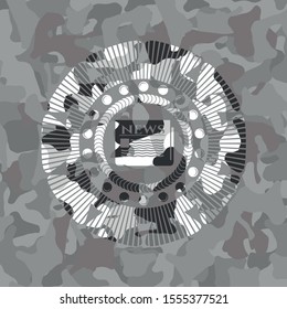 newspaper icon inside grey camouflaged emblem