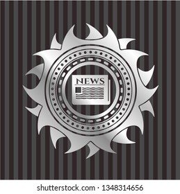 newspaper icon inside silver emblem or badge
