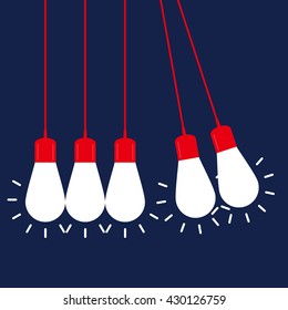 Newton's cradle with glowing light bulb. Pendulum. Leadership, power and uniqueness concept.