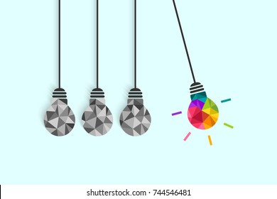 Newton's cradle pendulum with hanging light bulbs as idea and creativity concept. Colorful bulb among plain grey ones.