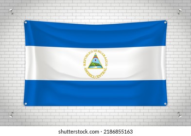 Nicaragua flag hanging on brick wall. 3D drawing. Flag attached to the wall. Neatly drawing in groups on separate layers for easy editing.