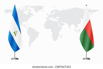 Nicaragua and Madagascar flags for official meeting against background of world map.