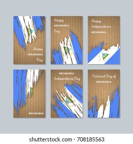 Nicaragua Patriotic Cards for National Day. Expressive Brush Stroke in Flag Colors on kraft paper background. Vector Greeting Card.