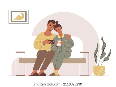 Nice cartoon young couple sitting on a sofa and watching content on the phone. A family in a cozy interior.