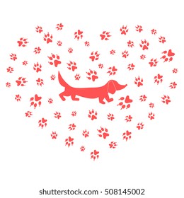 Nice picture of dachshund silhouette on a background of dog tracks in the form of heart on a white background.