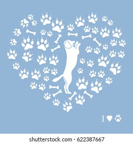 Nice picture of dog standing on its hind legs silhouette on a background of dog tracks and bones in the form of heart on a colored background.