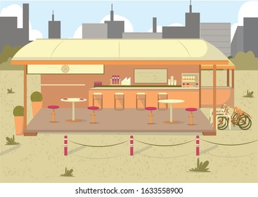 Nice Place to Grab Bite When Weather Warms Up. Restaurant with Outdoor Seating. Open Air Dining Option with Bicycle Parking Rack. Big City with Skyscrapers and Office Buildings in Background.