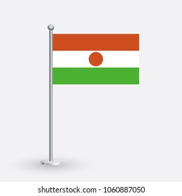 Niger flag. The national flag of Niger on a pole. The waving flag. The sign and symbol of the country. Realistic vector on white.