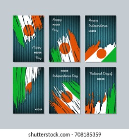 Niger Patriotic Cards for National Day. Expressive Brush Stroke in National Flag Colors on dark striped background. Niger Patriotic Vector Greeting Card.