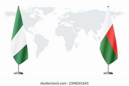 Nigerian and Madagascar flags for official meeting against background of world map.