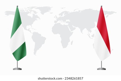 Nigerian and Monaco flags for official meeting against background of world map.