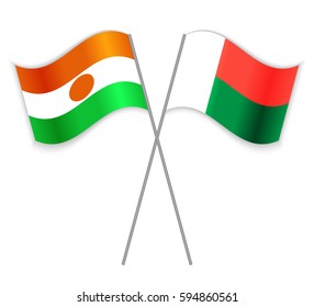 Nigerien and Malagasy crossed flags. Niger combined with Madagascar isolated on white. Language learning, international business or travel concept.