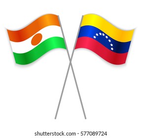 Nigerien and Venezuelan crossed flags. Niger combined with Venezuela isolated on white. Language learning, international business or travel concept.