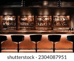 Night Bar, Night Club with high chair in front of the bartender shelf with bottles of liquors