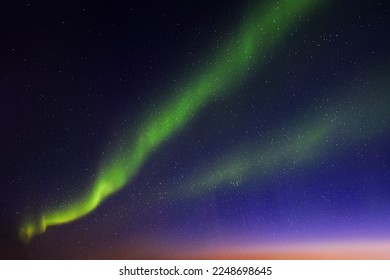 Night blue starry sky and Northern lights. Green aurora borealis