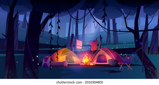 Night camping with tents, campfire in dark forest