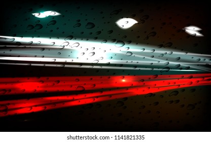 Night city. The trace of light. Raindrops on the glass.