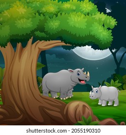 Night forest with a mother rhino and her cub under the tree